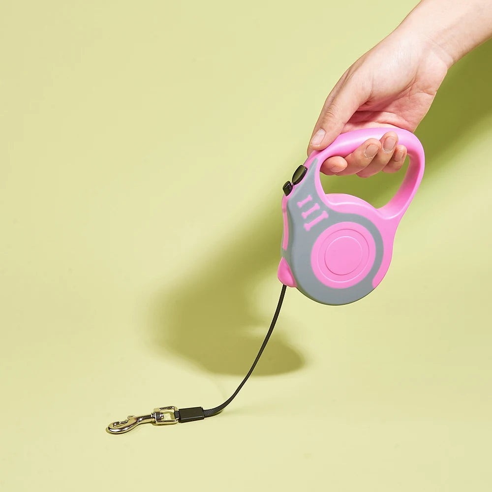 Soralab pink and grey retractable dog leash with anti-slip handle and one-button lock. Durable nylon tape.