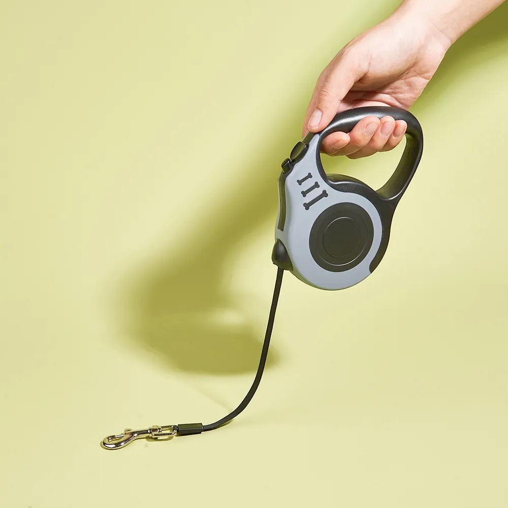 Soralab grey and black retractable dog leash with anti-slip handle and one-button lock. Durable nylon tape.