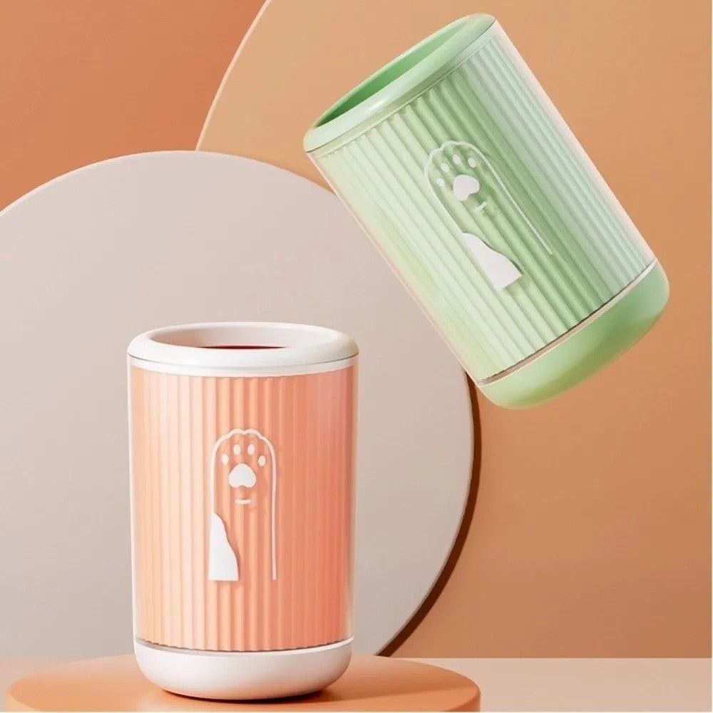 Soralab silicone dog paw cleaner cup in orange and green, featuring soft bristles and a paw print design.